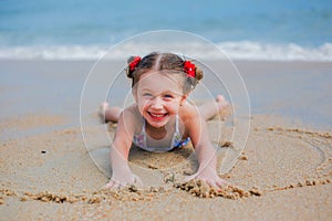 Adorable little girl at beach during summer vacation