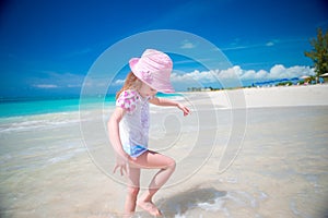 Adorable little girl at beach during summer vacation.