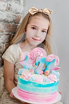 Adorable little girl with a birthday cake