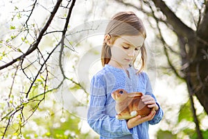 Adorable little girl in blooming cherry garden