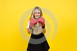 An adorable little girl boxer practicing punches in studio