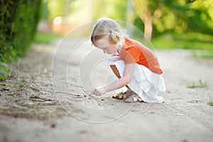 Adorable little girl catching little babyfrogs