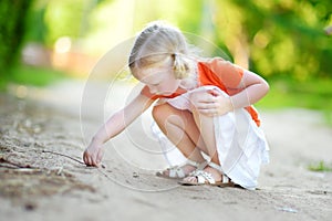 Adorable little girl catching little babyfrogs