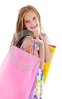 Adorable little girl child holding shopping colorful paper bags