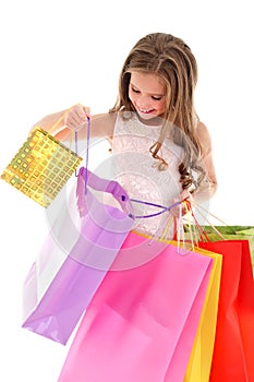 Adorable little girl child holding shopping colorful paper bags