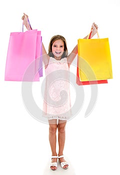 Adorable little girl child holding shopping colorful paper bags