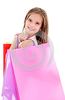 Adorable little girl child holding shopping colorful paper bags