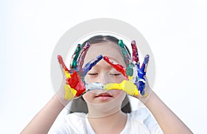 Adorable little girl closed eyes with gesture triangle colorful hands painted over white background