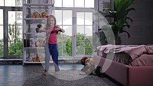 Adorable little girl dancing on carpet in nursery