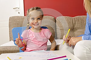 Adorable little girl drawing with felt pen