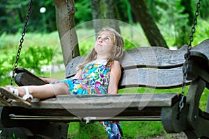 Adorable little girl drawing outside with chalk