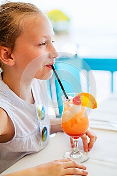 Little girl drinking mocktail outdoors photo