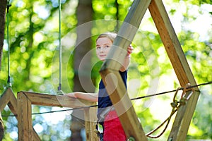 Adorable little girl enjoying her time in climbing adventure park