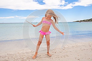 Adorable little girl enjoying tropical beach