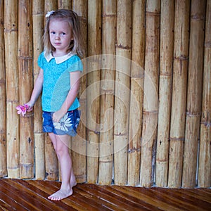 Adorable little girl in exotic tropical resort