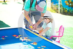 Adorable little girl fishing.