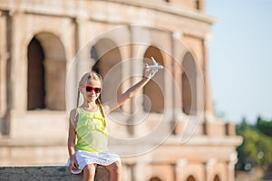 Adorable little girl in front of Colosseum in Rome, Italy. Kid on italian vacation