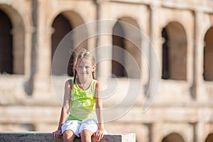 Adorable little girl in front of Colosseum in Rome, Italy. Kid in italian vacation