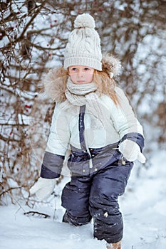 Adorable little girl in frozen winter day outdoors