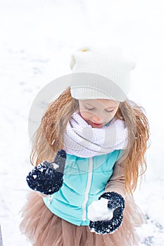 Adorable little girl in frozen winter day outdoors