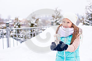 Adorable little girl in frozen winter day outdoors