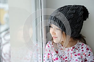 Adorable little girl in grey knit hat