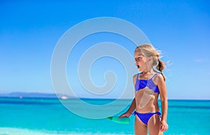 Adorable little girl have fun at tropical beach