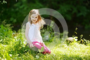 Adorable little girl having fun outdoors