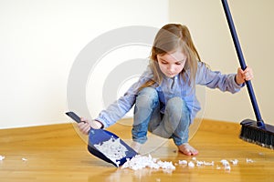 Adorable little girl helping her mom to clean up