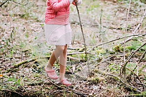 Adorable little girl hiking in the forest on summer day