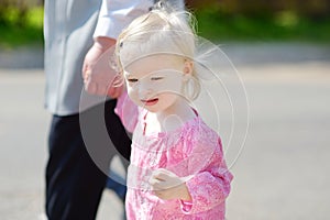 Adorable little girl holding hand of her gran