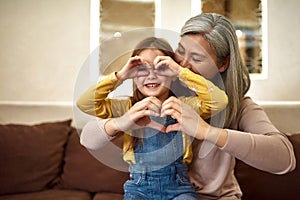 Lovely girl and grandmother having fun together