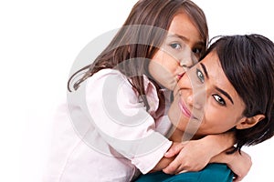 Adorable little girl kissing her mother's cheek