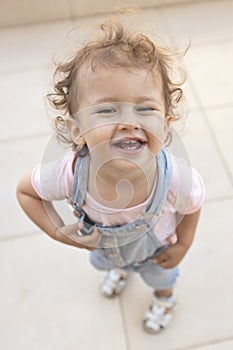Adorable little girl laughing. Happy smiling child looking at camera