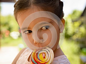 Adorable little girl with lollipop