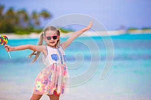 Adorable little girl with lollipop on tropical