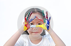 Adorable little girl looking through her triangle colorful hands painted over white background