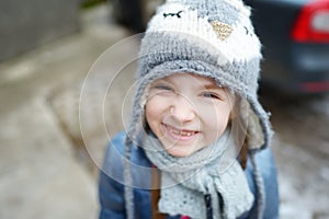 Adorable little girl making funny faces outdoors