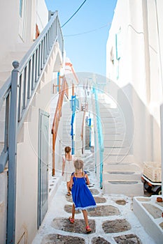 Adorable little girl at old street of typical greek traditional village