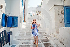 Adorable little girl at old street of typical greek traditional village