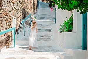 Adorable little girl at old street of typical greek traditional village