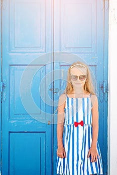 Adorable little girl at old street of typical greek traditional village