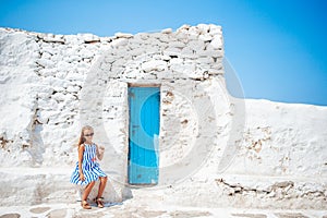 Adorable little girl at old street of typical greek traditional village