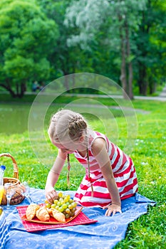 Adorable little girl on picnic outdoor near the