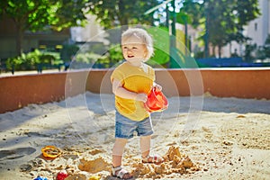 Adorable little girl on playground on a sunny day