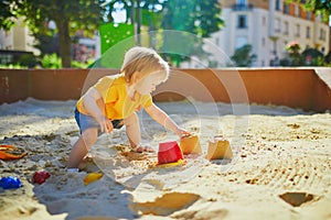 Adorable little girl on playground on a sunny day