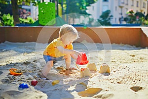 Adorable little girl on playground on a sunny day