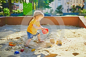 Adorable little girl on playground on a sunny day