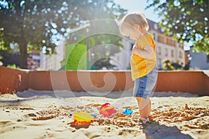 Adorable little girl on playground on a sunny day