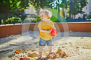 Adorable little girl on playground on a sunny day